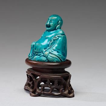 A turquoise glazed figure of Buddai, Qing dynasty, early 18th Century.