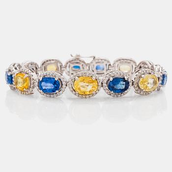 684. A yellow and blue sapphire and brilliant cut diamond bracelet. Total carat weight of sapphires circa 28.00 cts.