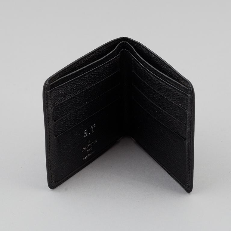 LOUIS VUITTON, black taiga leather wallet.