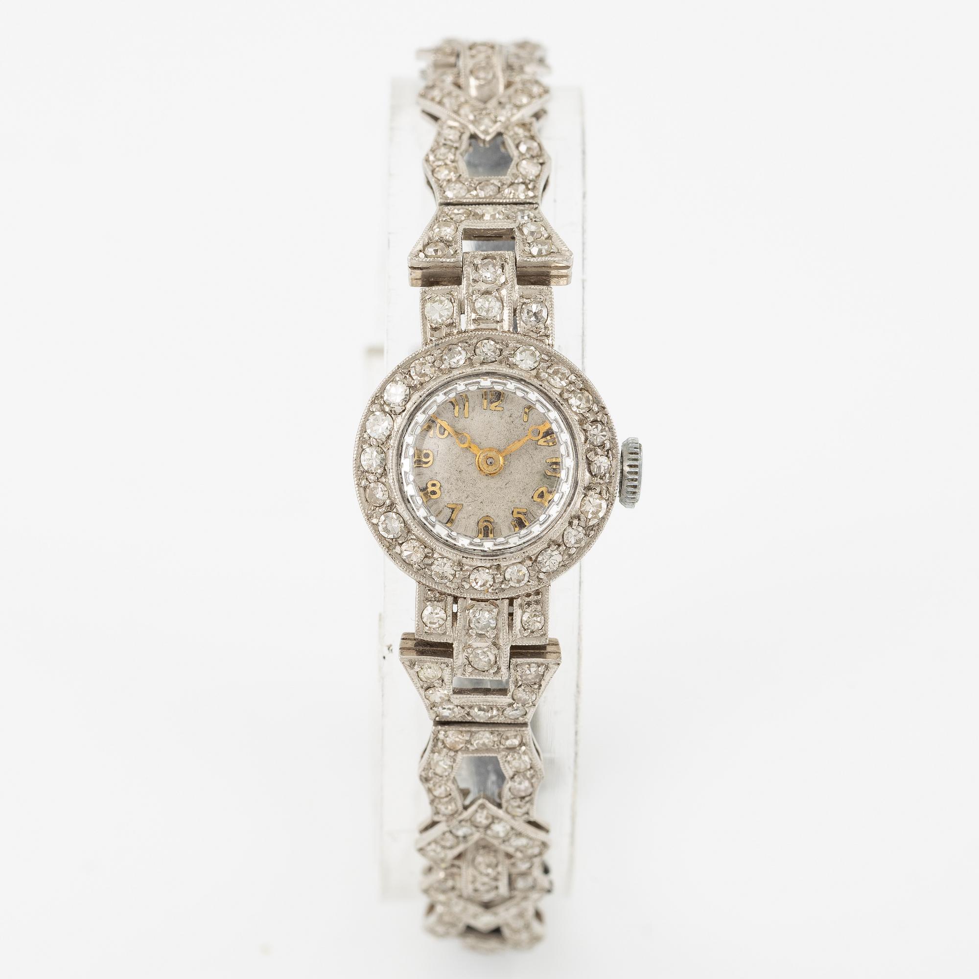 Damarmbandsur, platina med åttkantslipade diamanter, med textilrem.