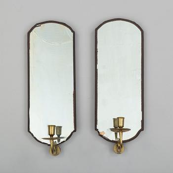 A pair of mirrors with candle sconces, partly 18th century.