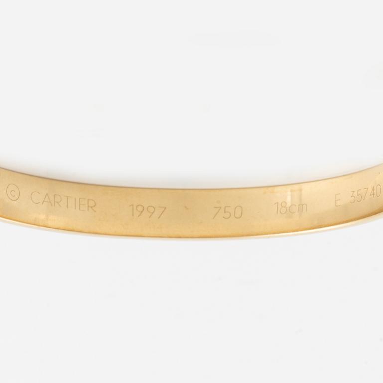 A Cartier "Anniversary Bracelet" in 18K gold set with a round brilliant-cut diamond.