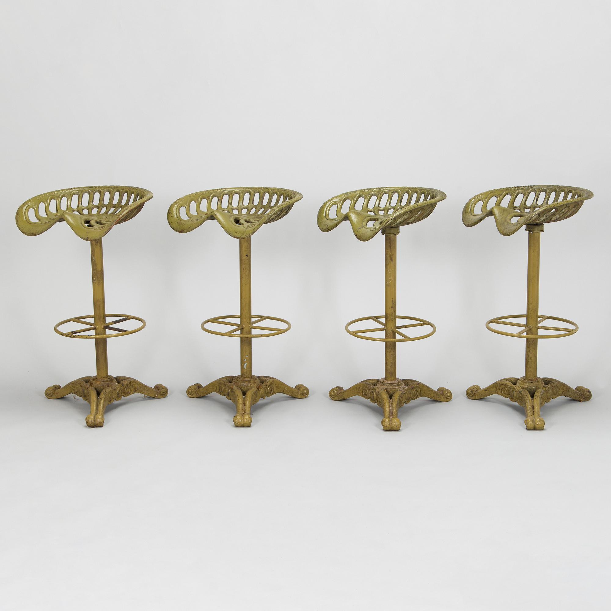 Four bar stools, painted cast iron, partly from the early 20th century.
