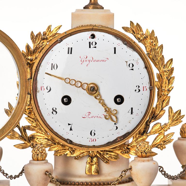 A Louis XVI gilt bronze and white and grey marble mantel clock.