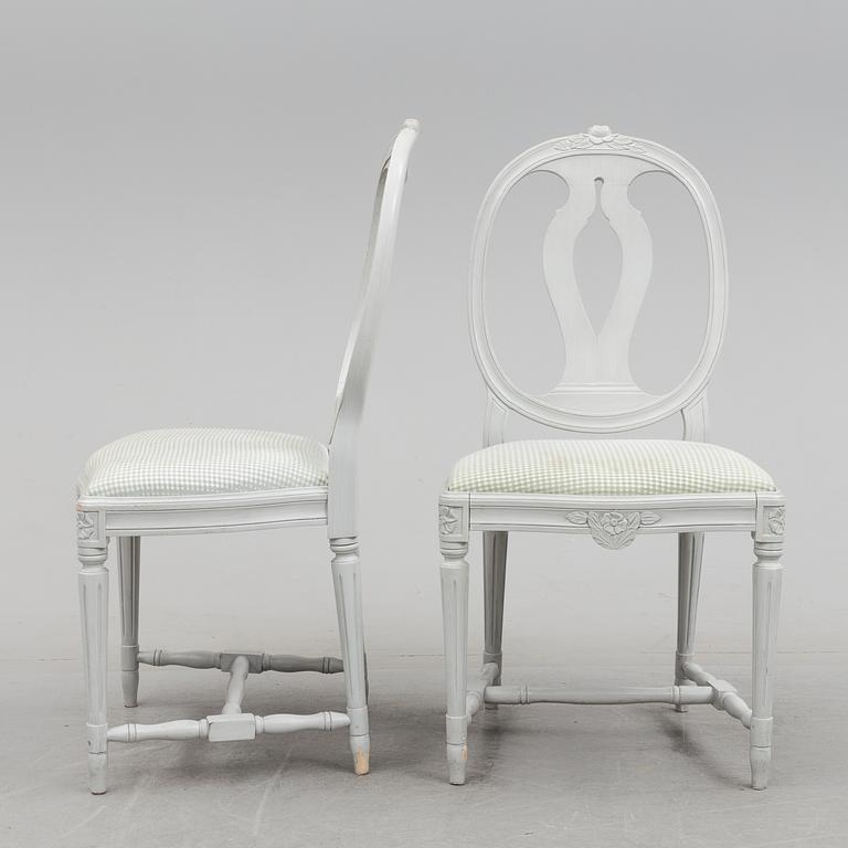 A Gustavian style dining table and ten chairs, 20th century.