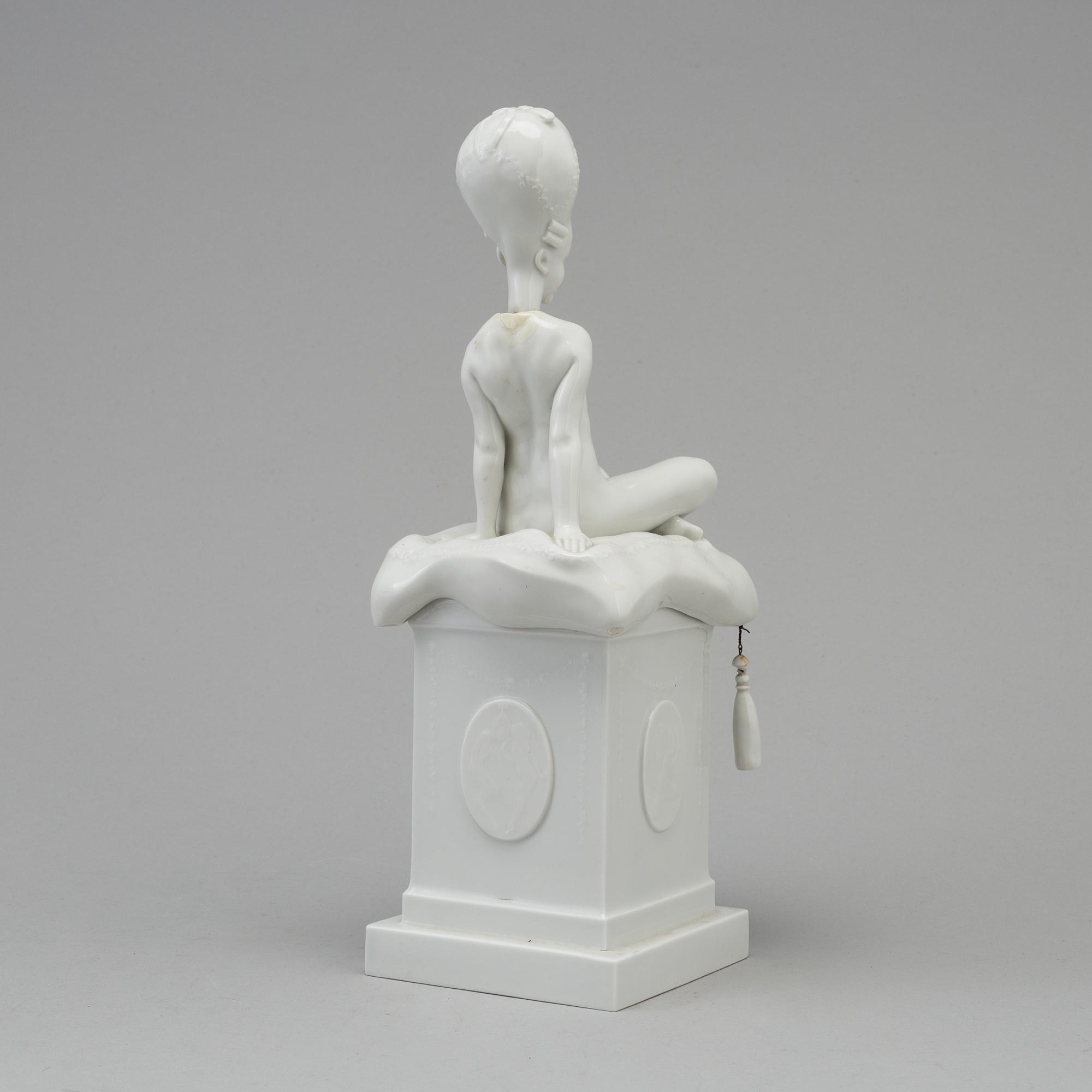 A white glazed Royal Copenhagen porcelain nodding head figure, Denmark, early 20th Century. Not first quality.