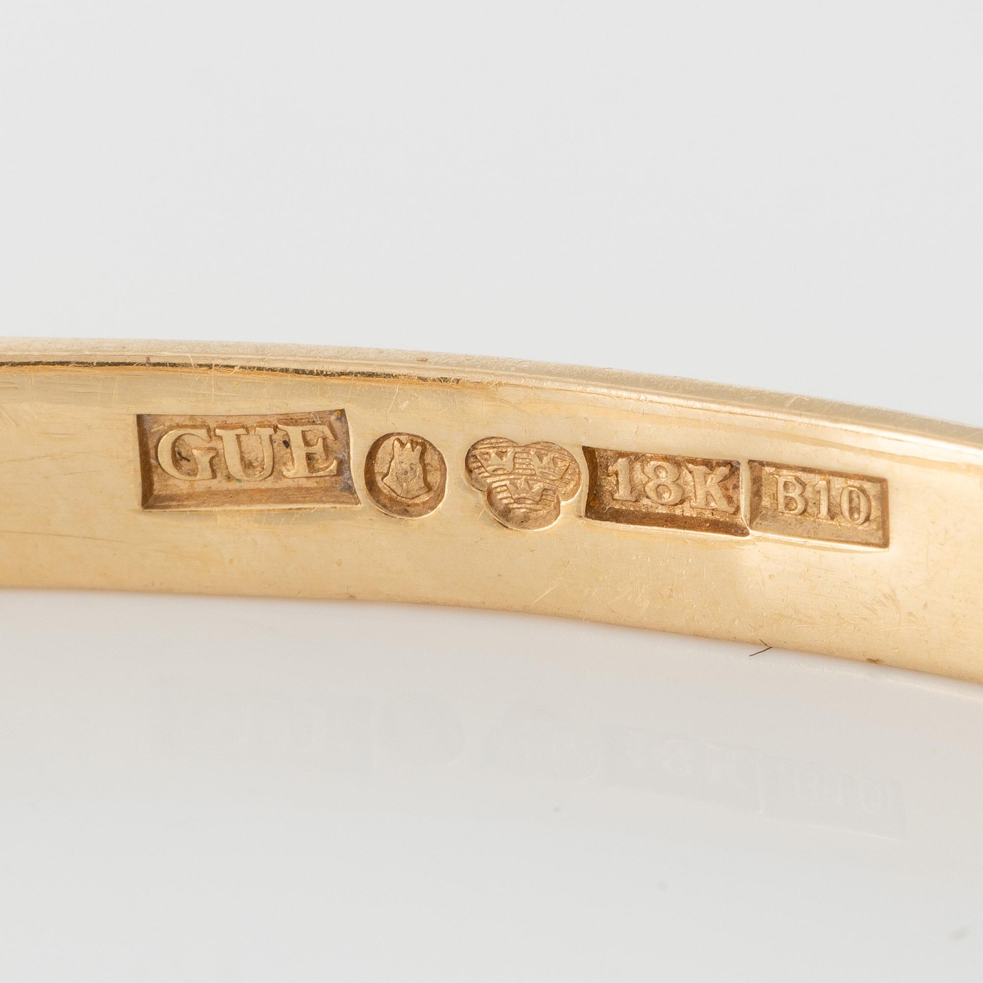 Bracelet 18K gold with green stone.