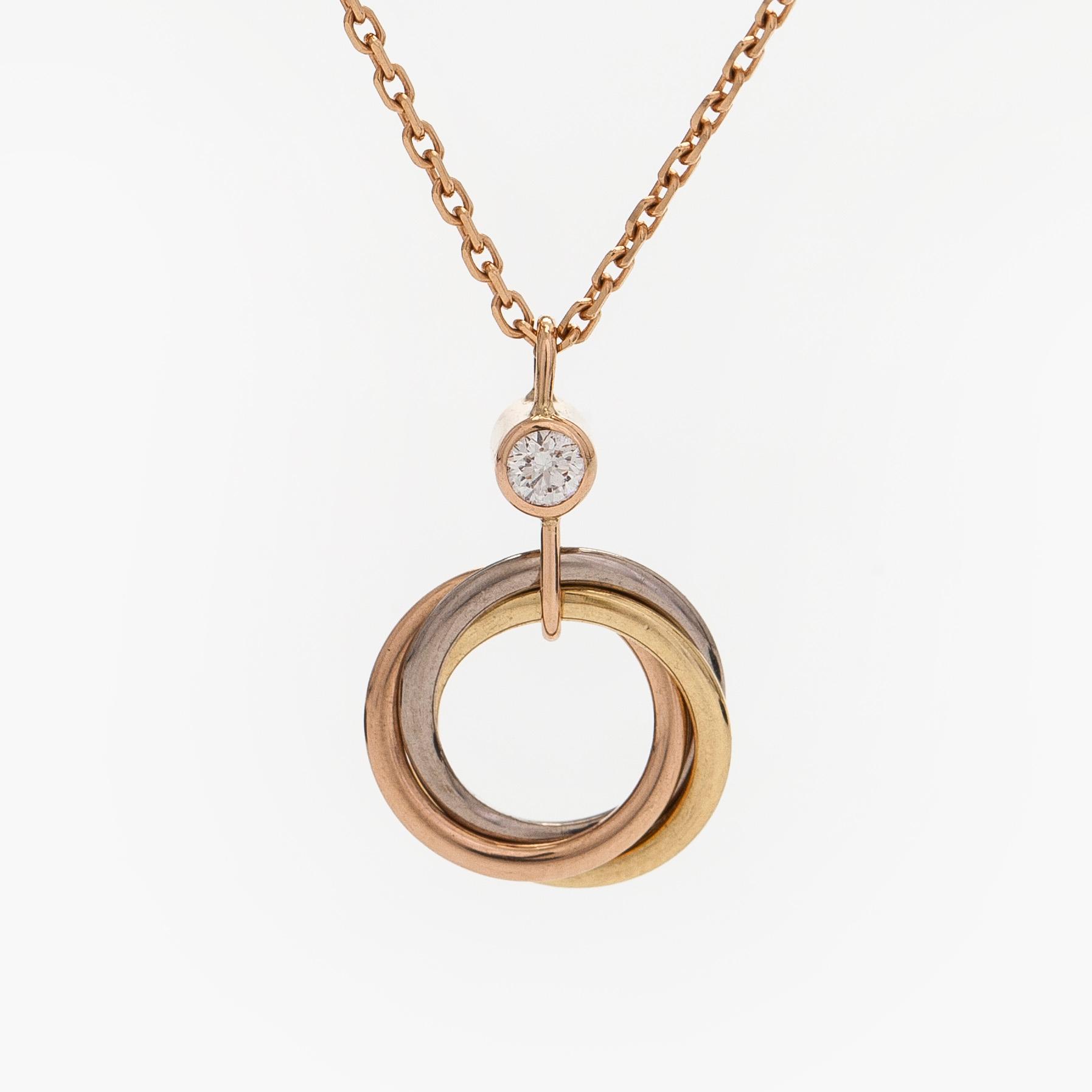 Cartier, an 18K gold 'Trinity Pendant' necklace with a brilliant-cut diamond.