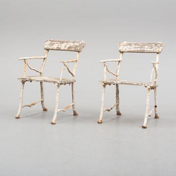 a pair of early 20th century garden cast iron chairs.