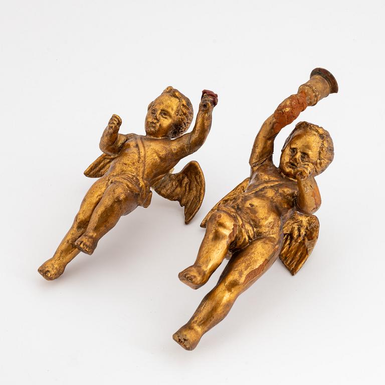 A pair of baroque wooden cupid sculptures, 18th century.