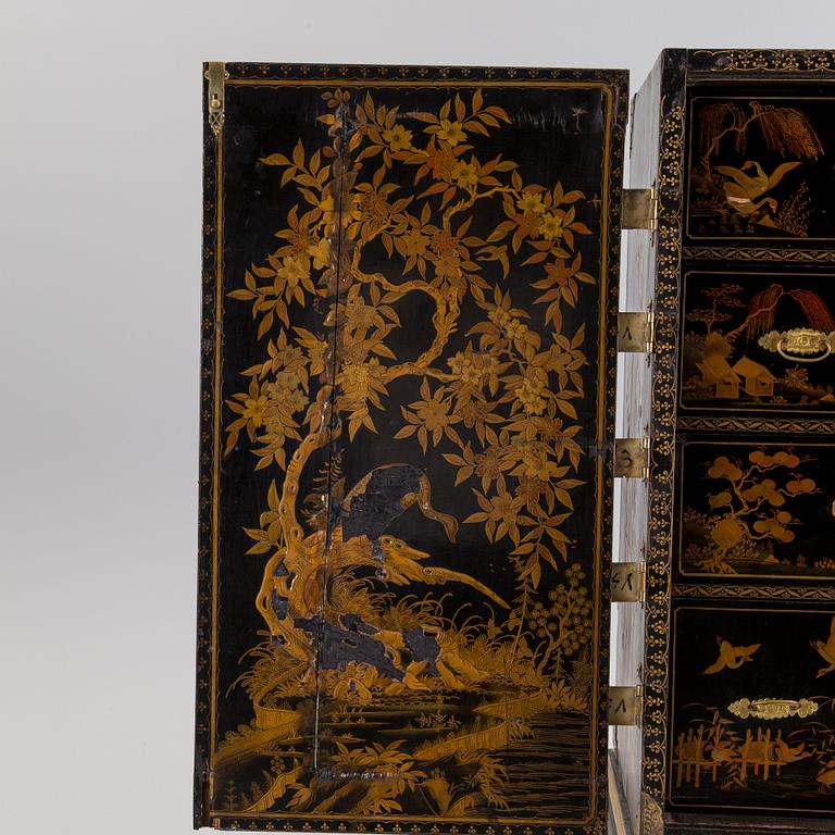 AN early 18TH CENTURY PROBABLY ENGLISH Japanned laquer cabinet on stand.