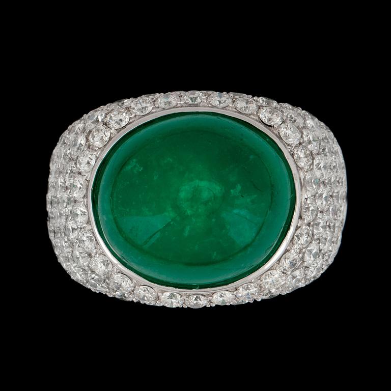 A cabochon cut emerald, circa 12.34 cts and pavé set diamonds, circa 3.59 cts, ring.