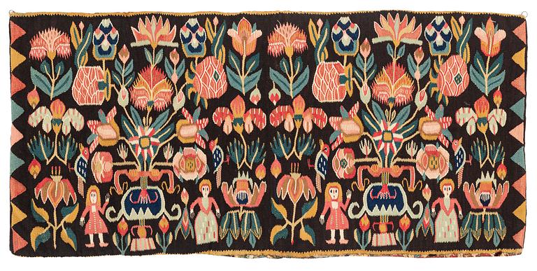 A carrige cushion, "Urnor och par", tapestry weave, ca 102 x 48,5 cm, around the years 1800-1830.
