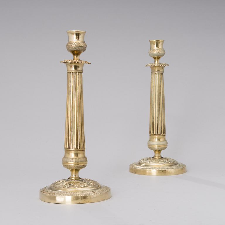 A pair of Empire bronze candlesticks from the first half of the 19th century.