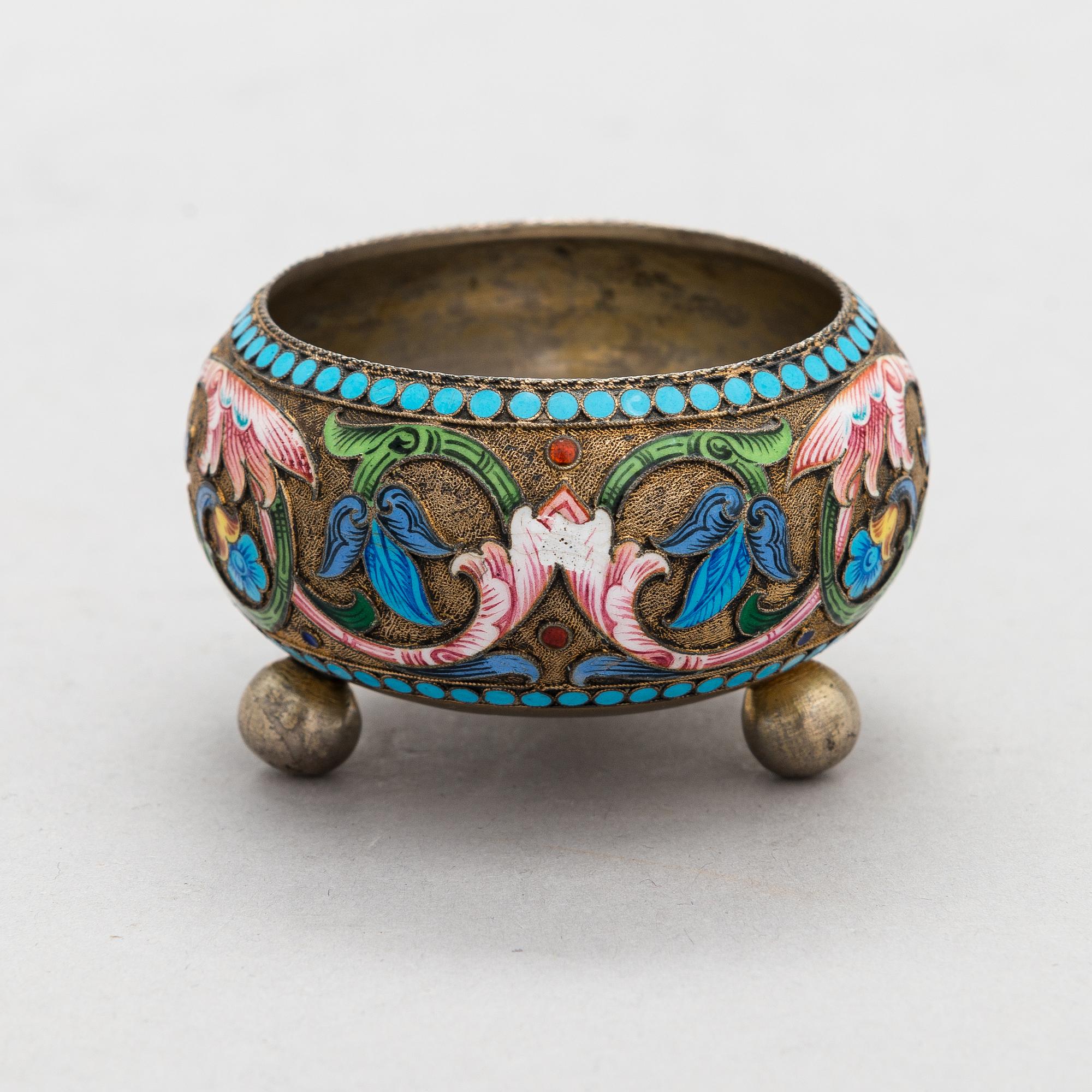 A salt cellar, mark of D. Nikitin, and 2 spoons, poss. P. Abrosimov and M. Andreyevna, enamel, silver. Moscow 1899-1908.
