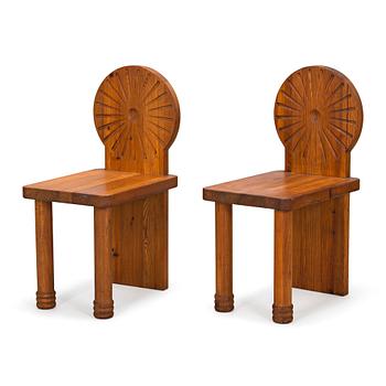 A pair of 1970s pine wood chairs.