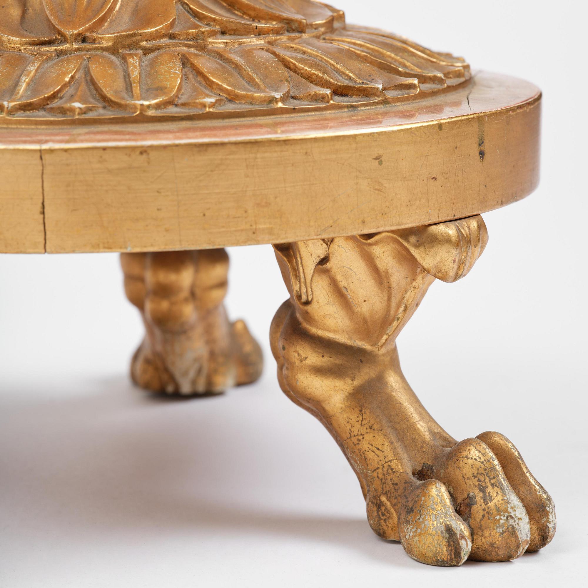 A pair of late Gustavian giltwood torchères by J. Frisk (master in Stockholm 1805-24).