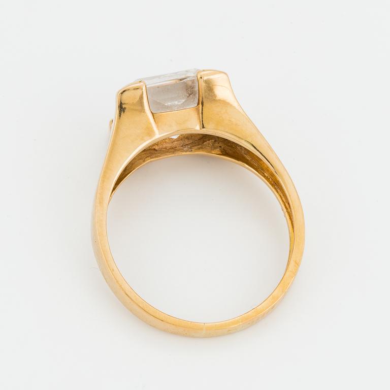 A synthetic white spinel, 18K gold.