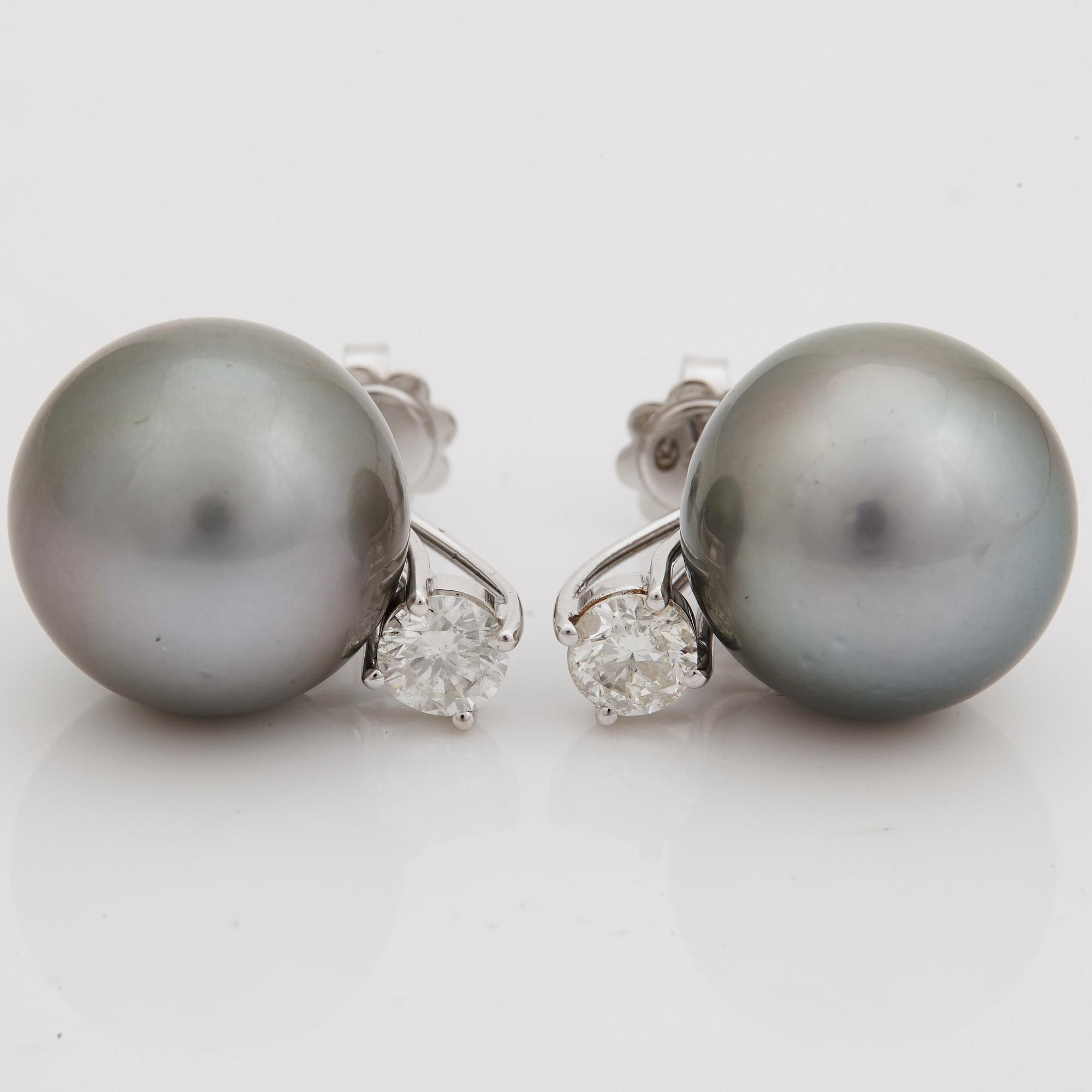 A pair of cultured Tahiti pearl and brilliant cut diamond earrings.
