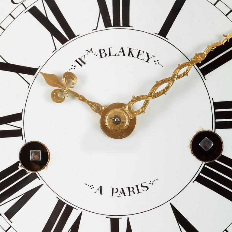 A Louis XV-style 19th century gilt bronze wall clock. Clockwork by W. M. Blakey, master in Paris 1755-74.