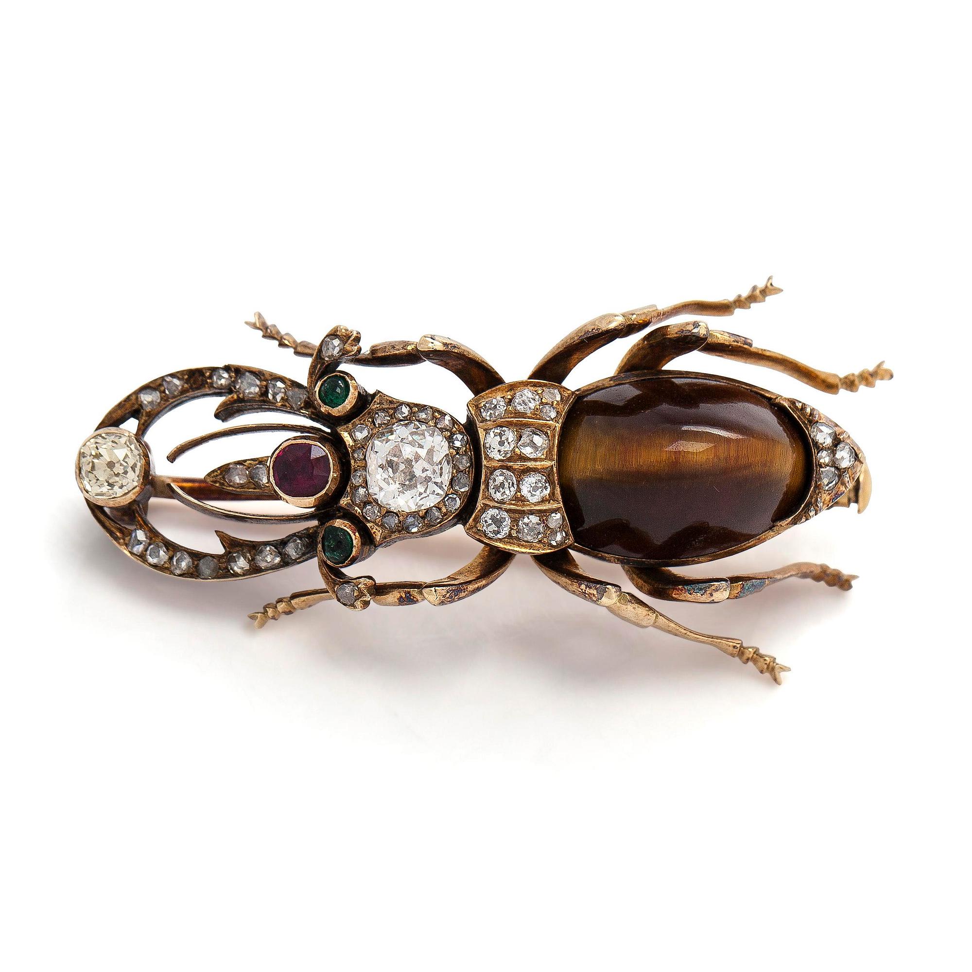A 14K gold brooch with tiger’s eye, old-cut and rose-cut diamonds, ruby, emeralds. St. Petersburg.
