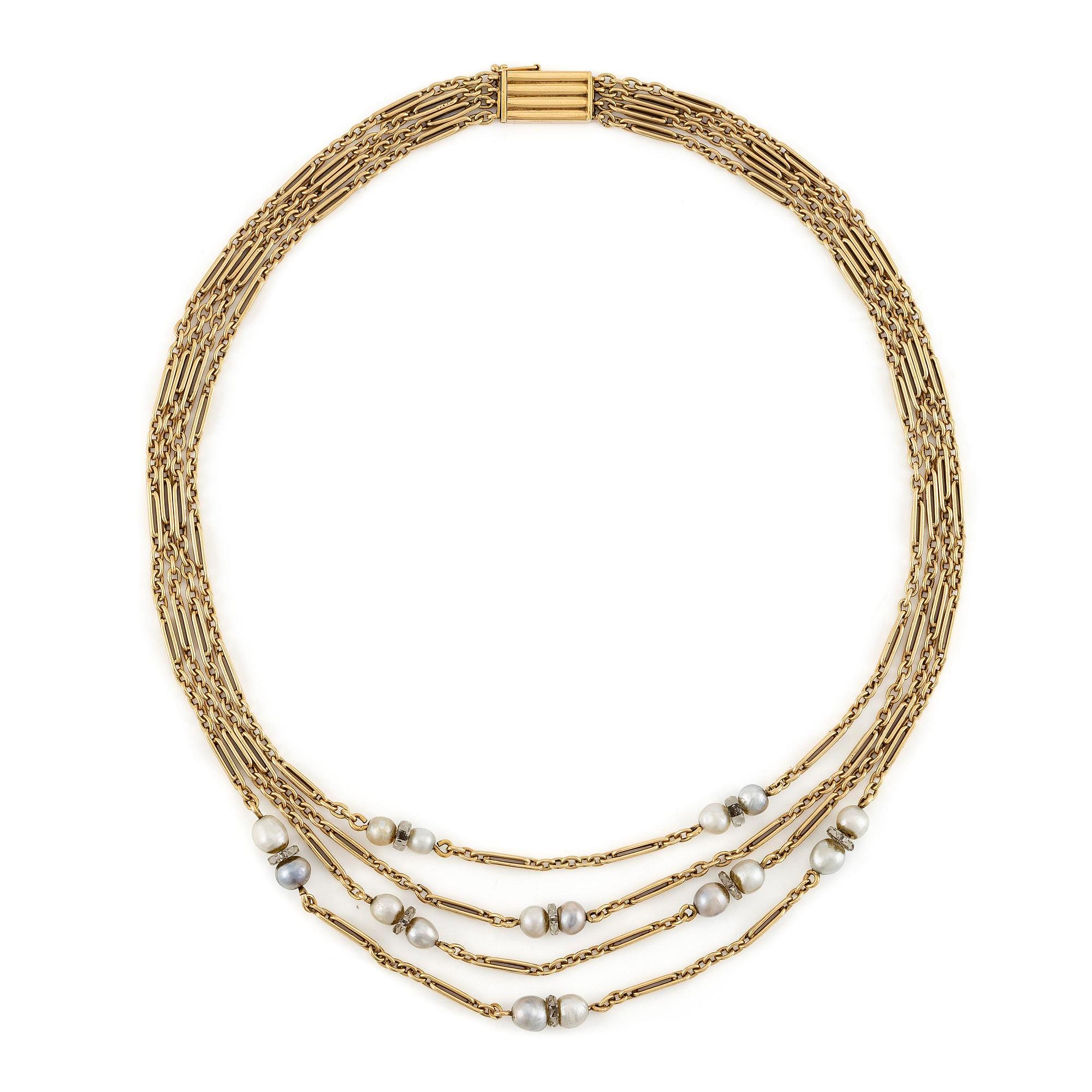 A W.A. Bolin necklace in 18K gold with pearls and white discs.