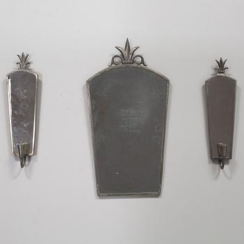 A pewter mirror and a pair of wall sconces from the first half of the 20th century.