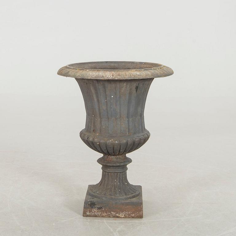 A cast iron garden urn.