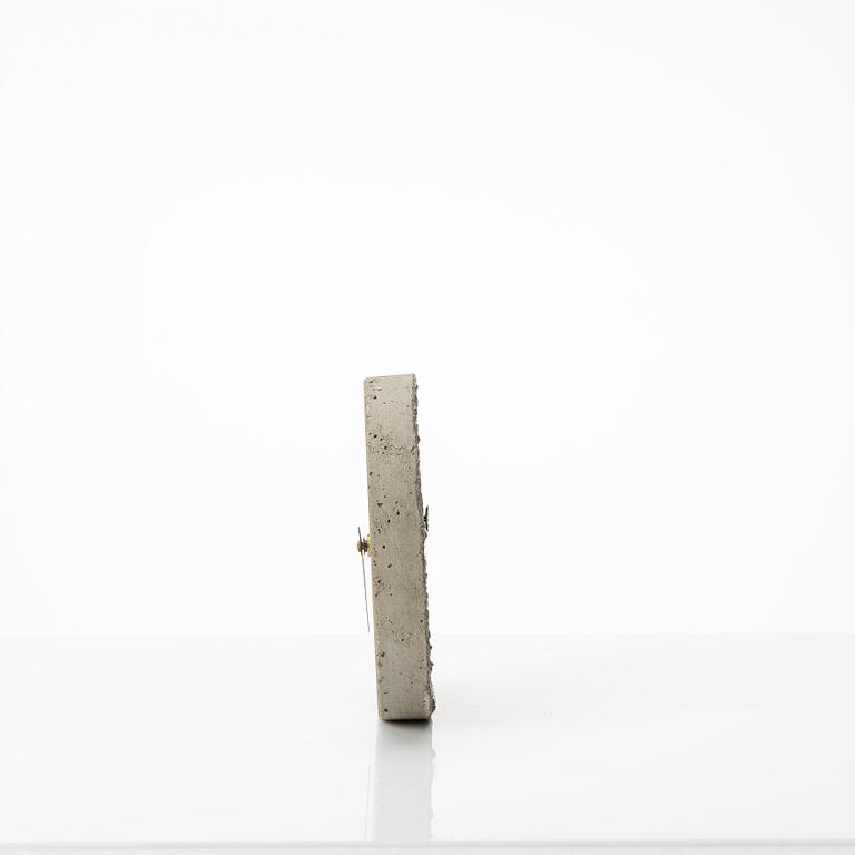 Stina Lindholm, a contemporary concrete planter 'Spira', a concrete flower pot and a wall clock.