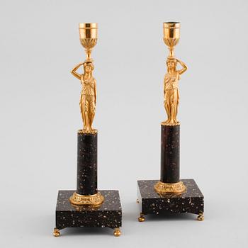 A pair of late gustavian early 19th century porphyry and ormolu candlesticks.