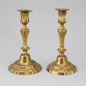 A pair of 18th century bronze candlesticks.
