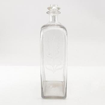 Brännvinsflaska, glas. Daterad Broby 1856.