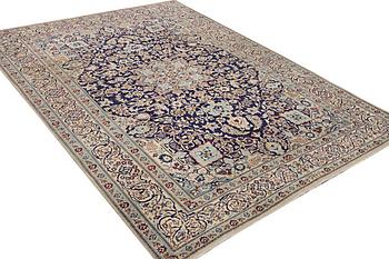 A Nain carpet, part silk, c. 338 x 244 cm.