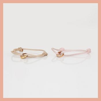 ARMBAND, 2st, tri-colour 18K guld samt tråd, Cartier, signerad och numrerad.