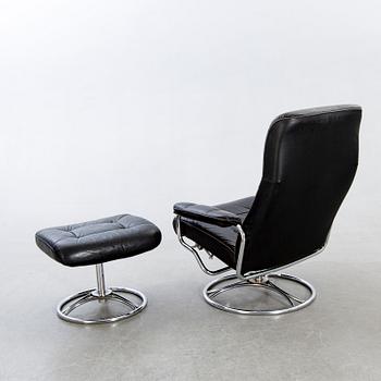 A leather swivel armchair and stool, Söderbergs  1980s.