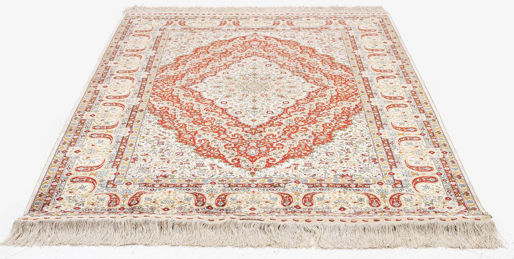 A semi-antique silk Hereke rug, West Anatolia, c. 180 x 121 cm.