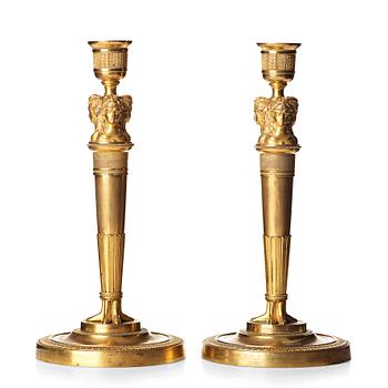 A pair of French Empire early 19th century gilt bronze candlesticks.