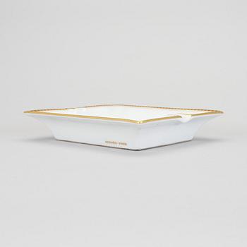 A Hermès porcelain ashtray.