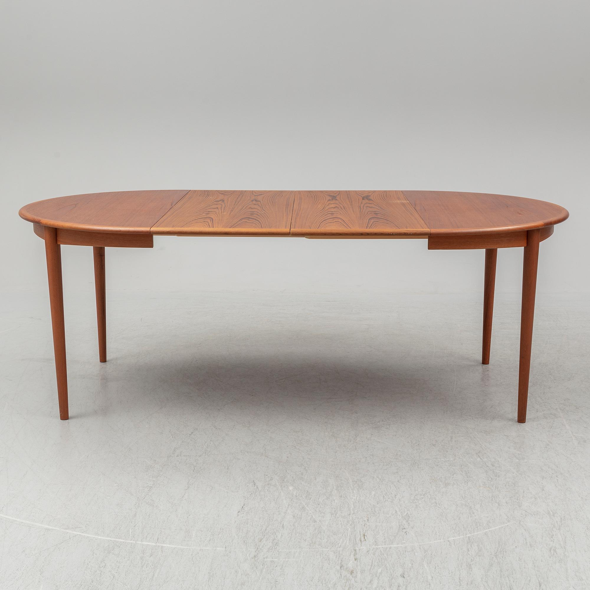 A 1960s teak veneered dining table.