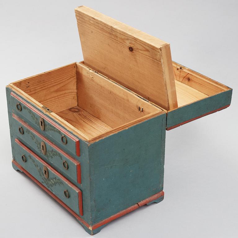 a miniature chest of drawers from the 19th century.