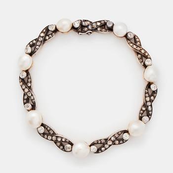 408. A bracelet in 18K gold and silver set with pearls and old- and rose-cut diamonds.