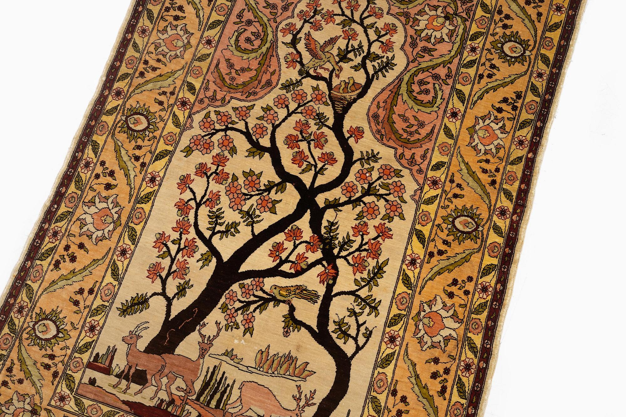 A semi-antique / old silk Hereke rug, West Anatolia, c. 100 x 60 cm.