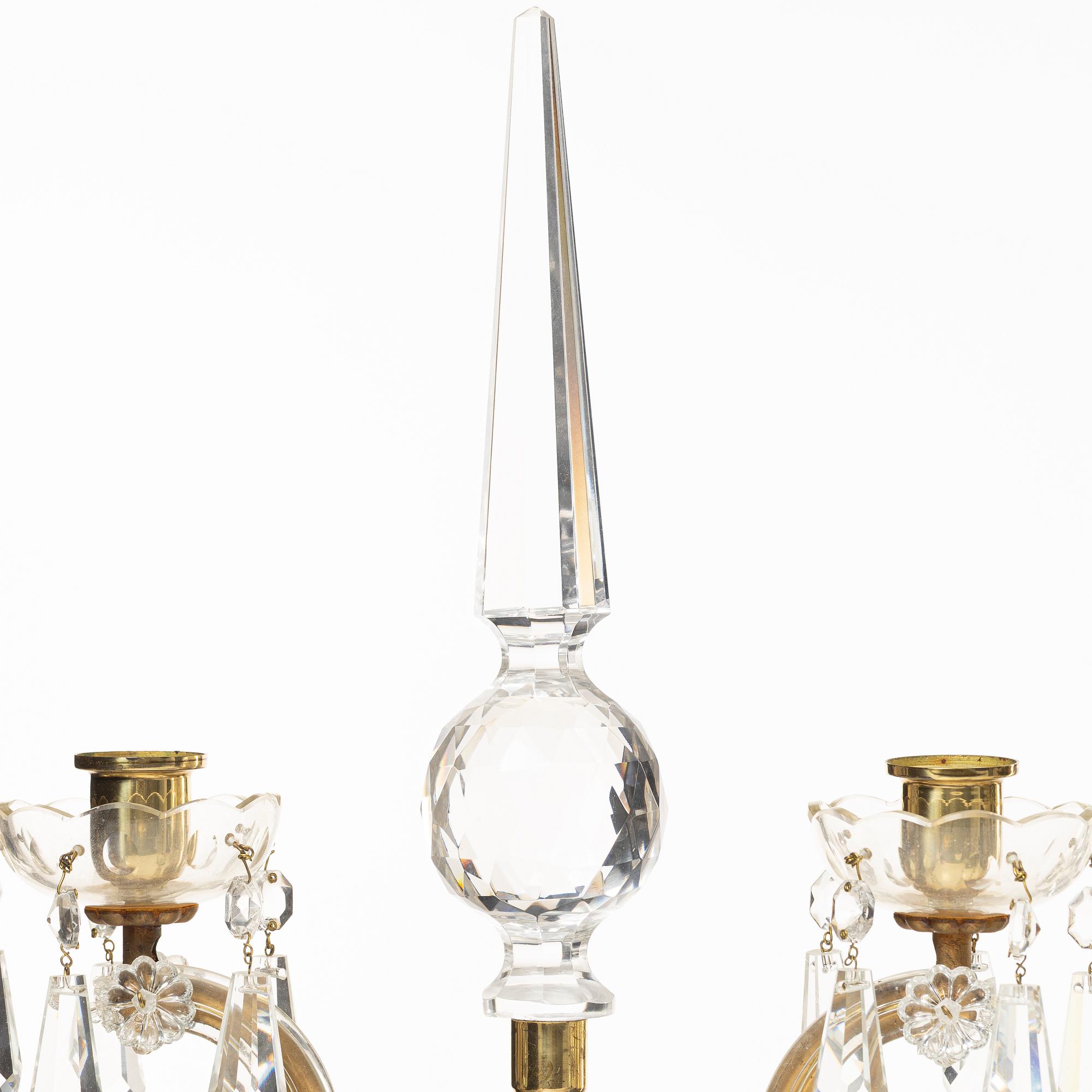 A pair of brass and glass canelabras, first half of the 20th century.