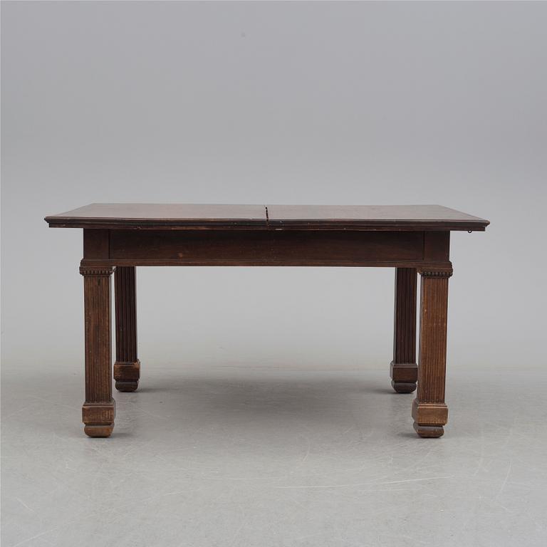 A 19th century dining table and a set of twelve chairs.