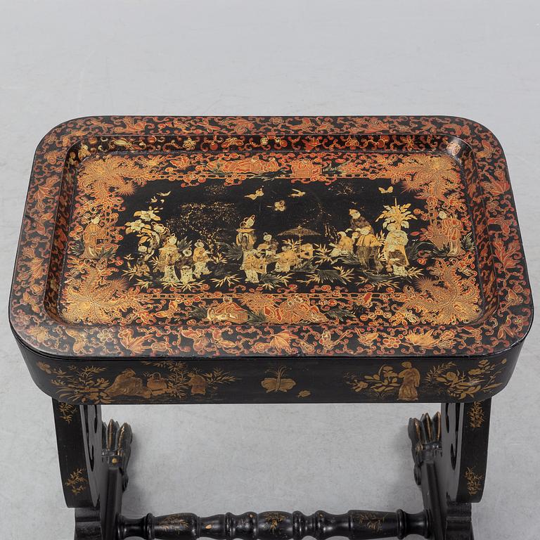 A black chinoiserie sewing table, second half of the 19th Century.