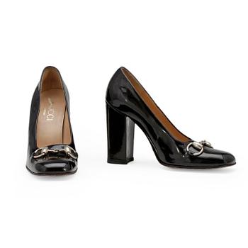 GUCCI, a pair of black patent leather shoes.