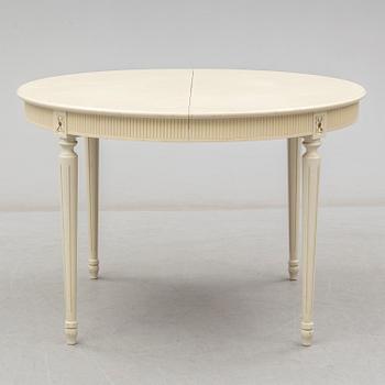 A set of eight chairs and a dining table. Gustavian style, second half of the 20th century. 2 leaves included.