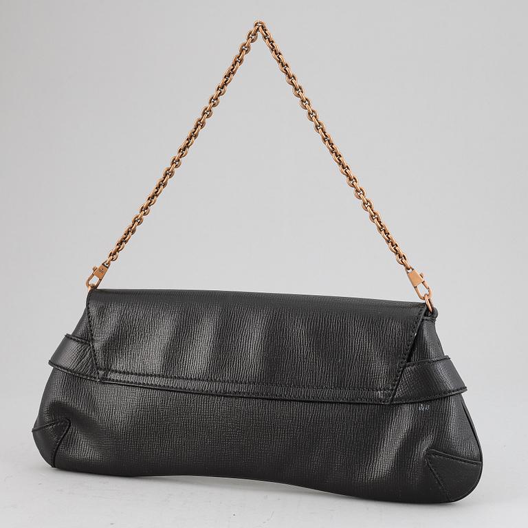 GUCCI, a black leather handbag.