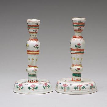 A pair of famille rose candle sticks, Qing dynasty, Qianlong (1736-95).