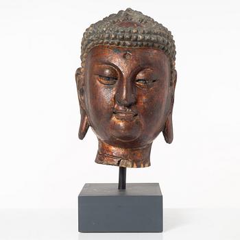 A large carved and lacquered wood head of Buddha, Ming style but later.